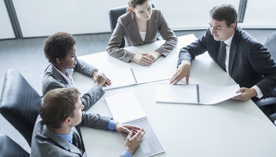 Four business people having a meeting, high angle view