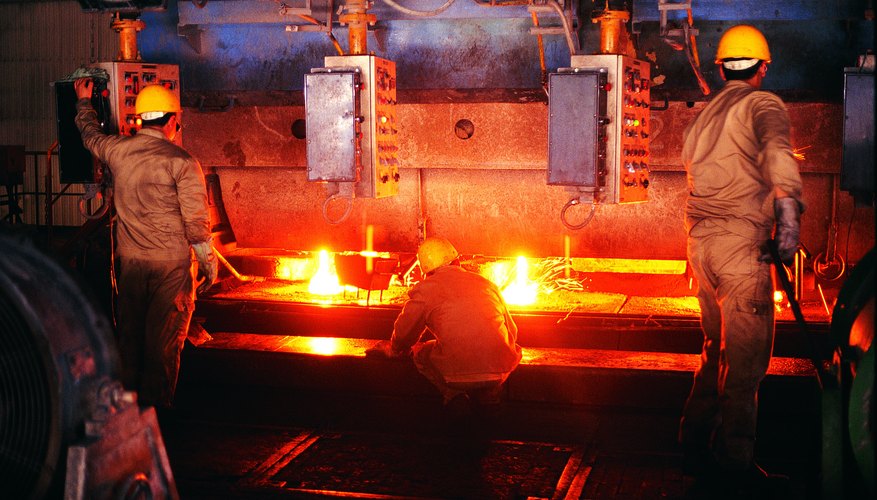 Photo Credit: Photodisc/Photodisc/Getty Images Foundry workers testing steel