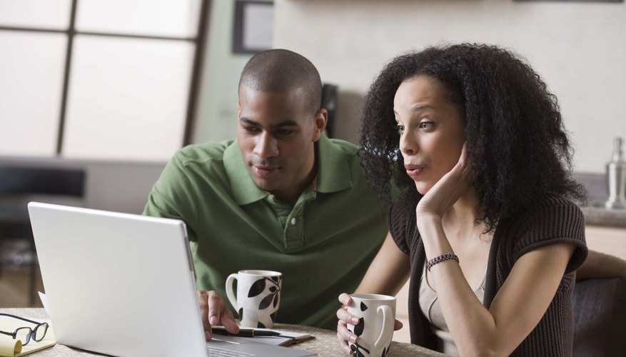 Photo Credit: Jupiterimages/Stockbyte/Getty Images Couple working from laptop