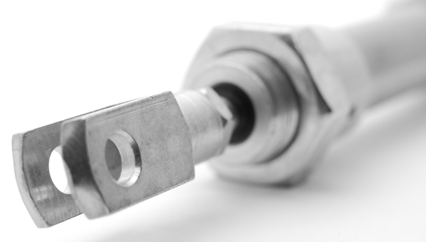 A pneumatic cylinder provides force from high-pressure air. A pneumatic cylinder provides force from high-pressure air.