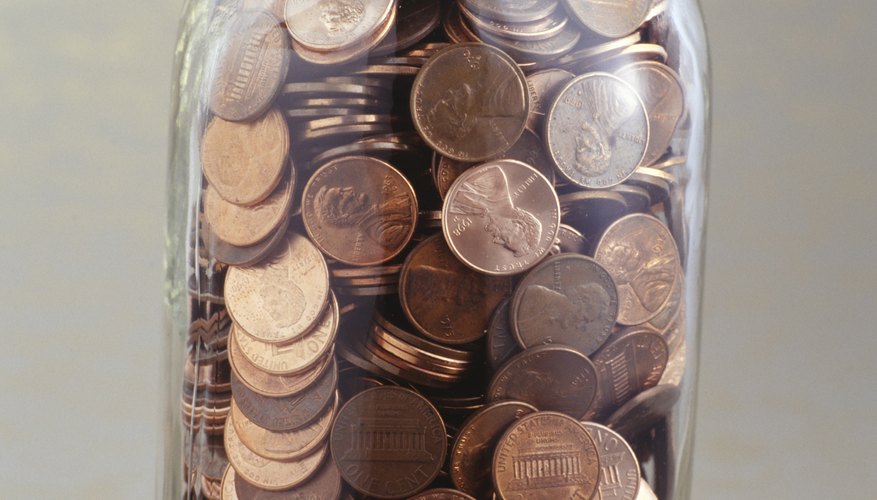 Photo Credit: Photodisc/Photodisc/Getty Images Pennies discolor over time simply by being handled.