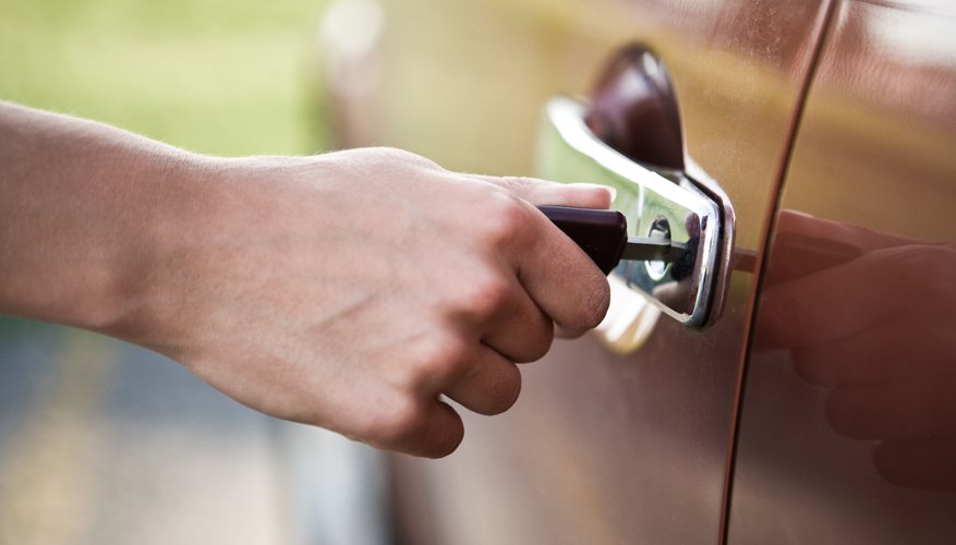 Hand unlocking car door with key