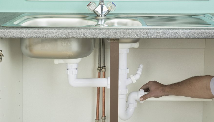 Photo Credit: Gary Ombler/Dorling Kindersley RF/Getty Images Pipes underneath sink.