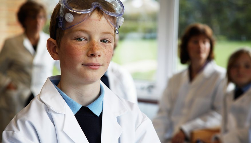 Photo Credit: Ableimages/Digital Vision/Getty Images Young boy with lab coat and goggles in science class.