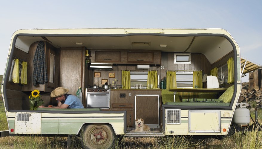 man trimming flower in trailer