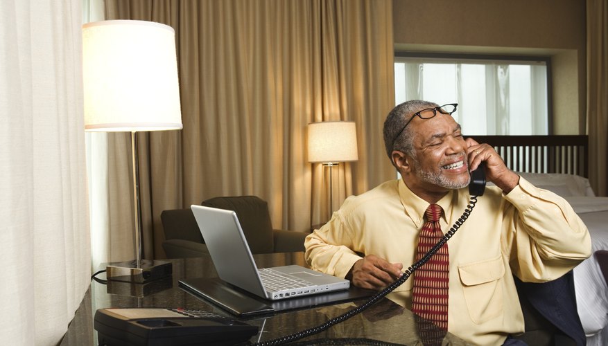 Businessman on telephone in hotel room