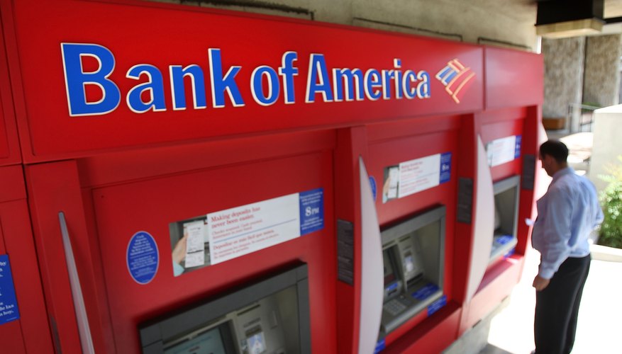 A man uses an ATM machine at a Bank of America branch.
