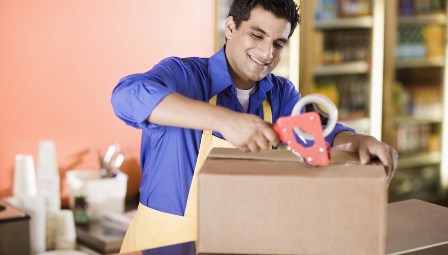 Man packing box at deli counter