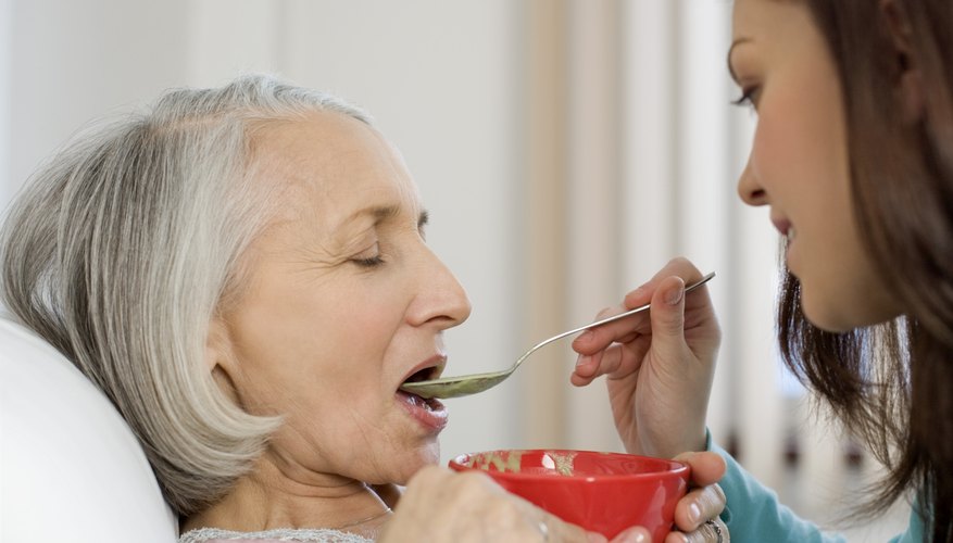 Woman feeding patient