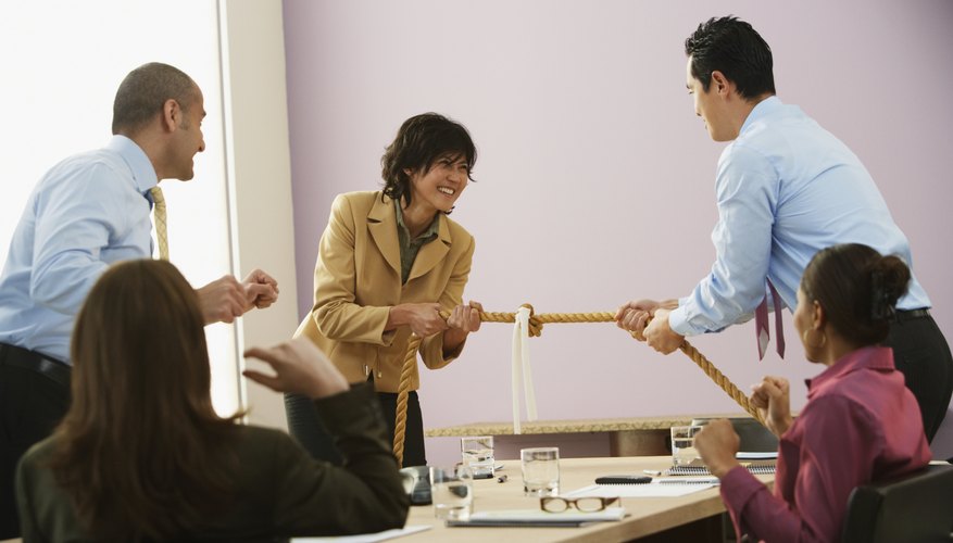 Businesspeople playing tug of war