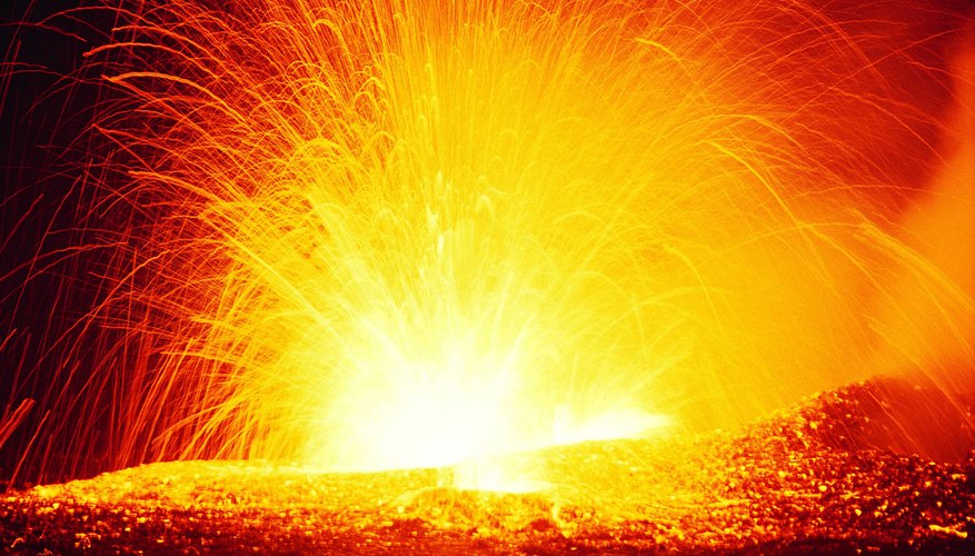Photo Credit: Digital Vision./Digital Vision/Getty Images A volcano spews hot lava.