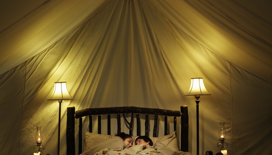A young couple in bed with lit candles. A young couple in bed with lit candles.