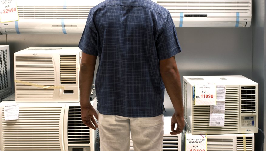Man looking at air conditioner in supermarket
