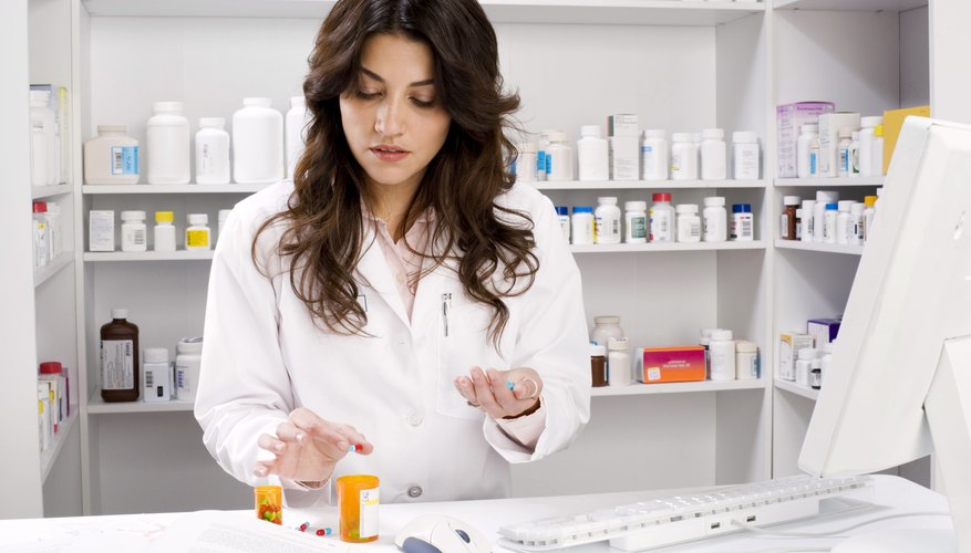 Pharmacist counting pills Pharmacist counting pills