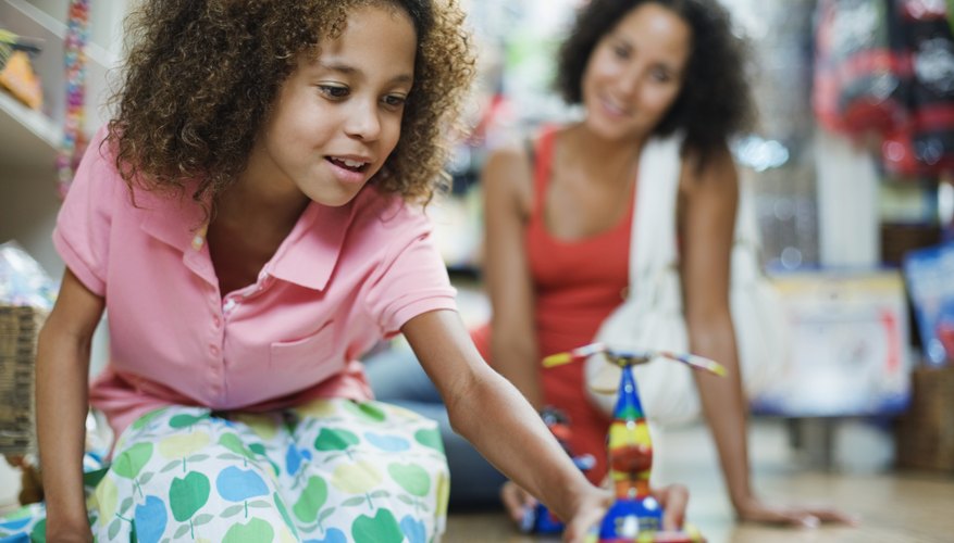 Photo Credit: Fuse/Fuse/Getty Images Girl playing with toy