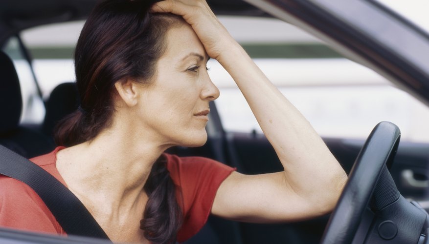Side profile of a mid adult woman in her car
