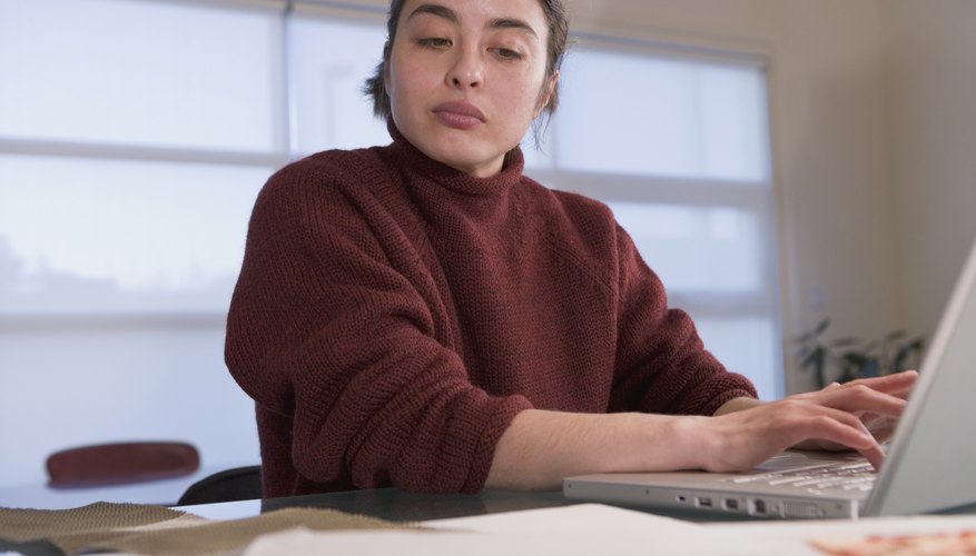 Mixed Race woman typing on laptop