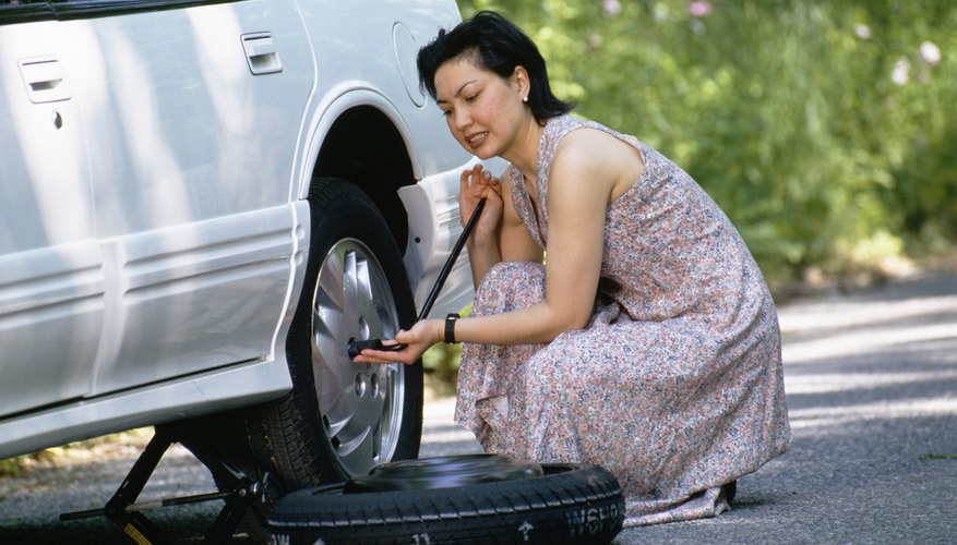 Woman changing flat tire