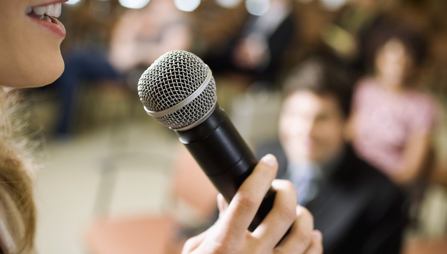 Photo Credit: Fuse/Fuse/Getty Images Woman speaking to audience on microphone