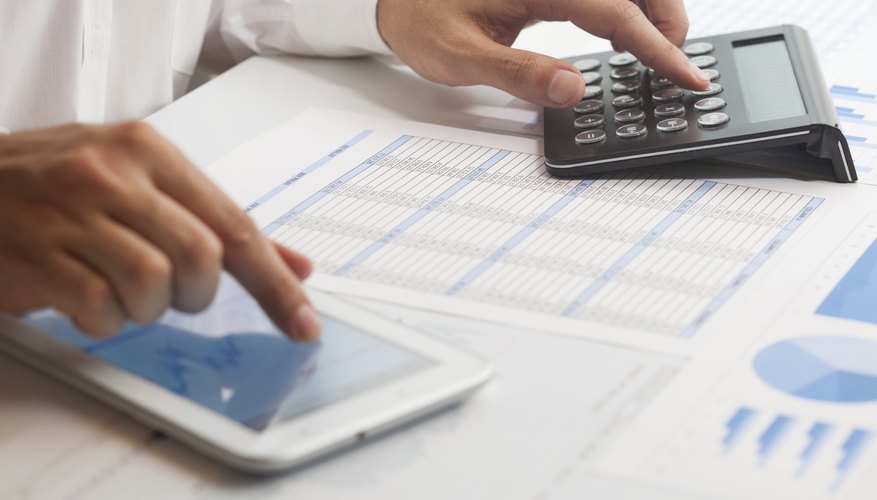 A businessman is working on a financial analysis.