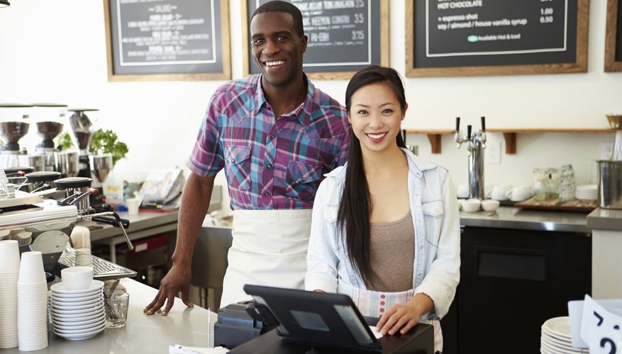 Male And Female Staff In Coffee Shop