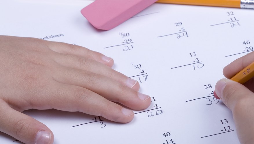 A close-up of a child working on subtraction math problems. A close-up of a child working on subtraction math problems.