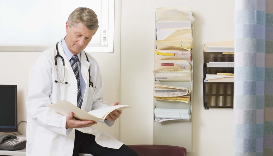 doctor looking at file doctor looking at file