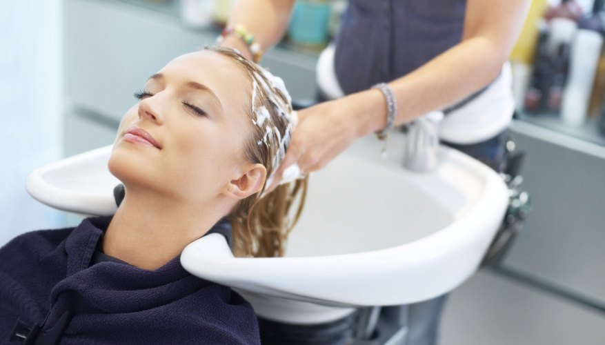 Photo Credit: Jacob Wackerhausen/iStock/Getty Images woman having hair washed in salon