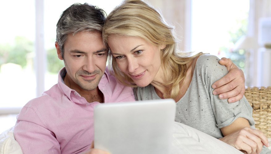 40 year old couple looking at document