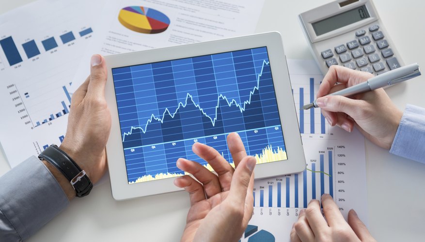 Businesspeople Analyzing Graph With Digital Tablet