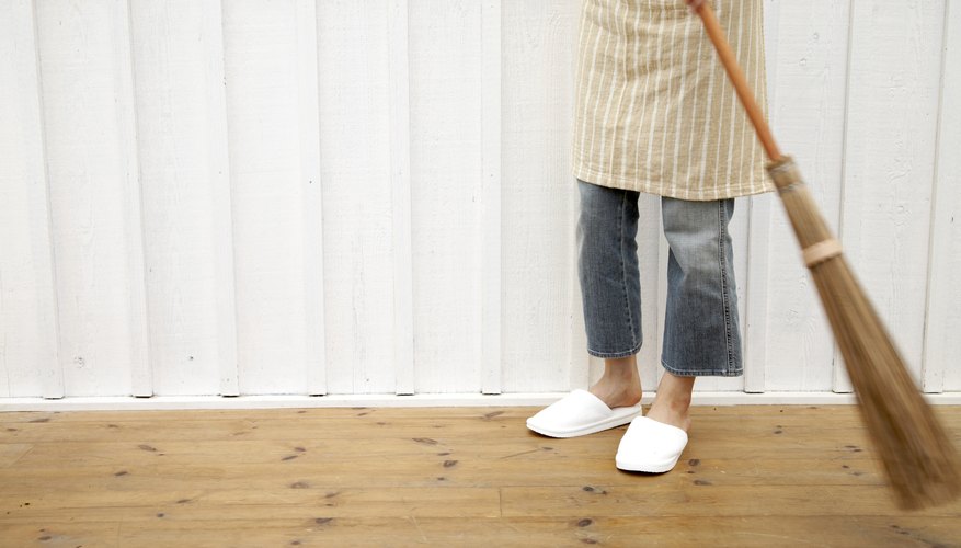 Use a broom to comb over the rug to collect the loose fibers Use a broom to comb over the rug to collect the loose fibers