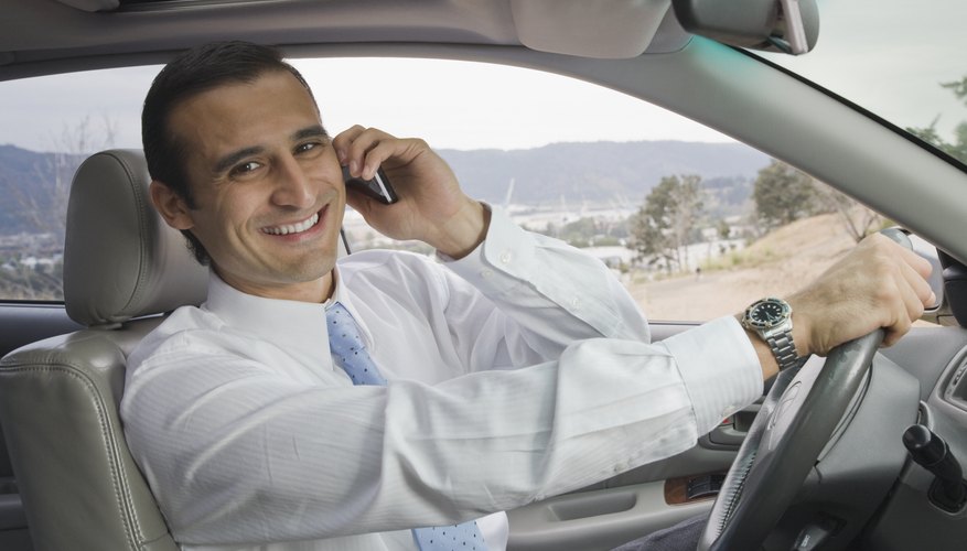 A man is on his cell phone driving to work.
