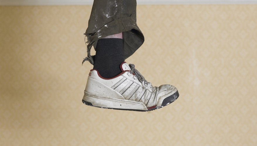 Human leg dangling from hole in ceiling