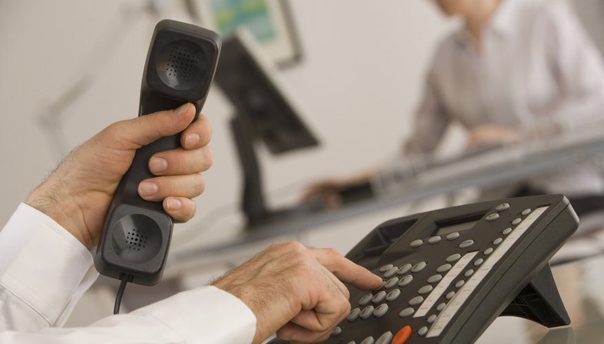 Man dialing telephone