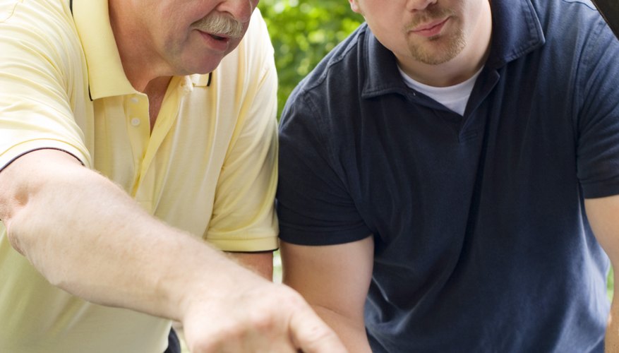 Father and son repairing car