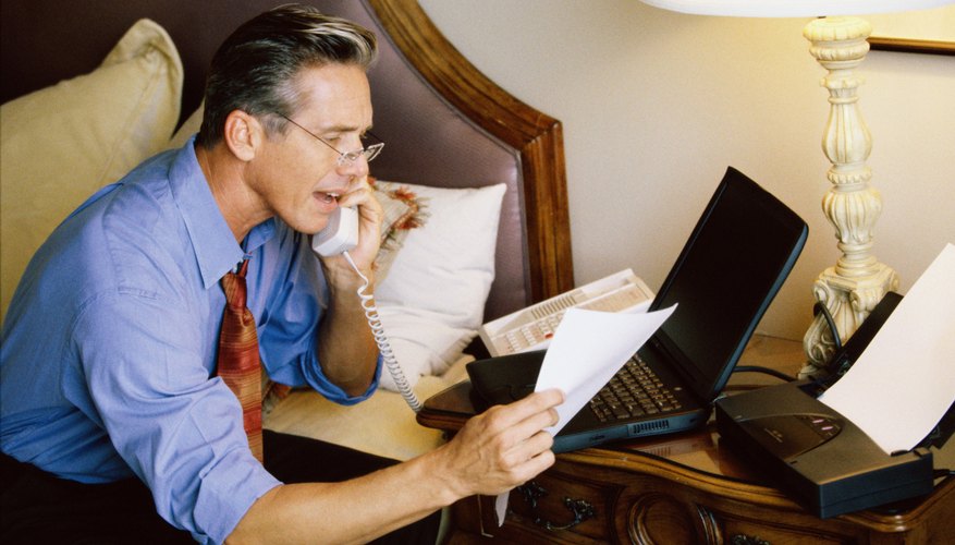 Side profile of a businessman talking on a telephone