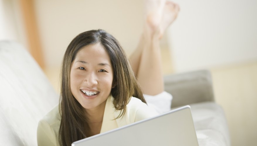 Smiling young woman working on laptop