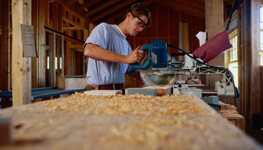 Carpenter Sawing Wood at a Construction Site