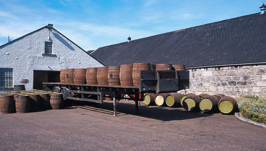 Photo Credit: Jupiterimages/Photos.com/Getty Images Liquor is often aged in wooden barrels to improve taste.