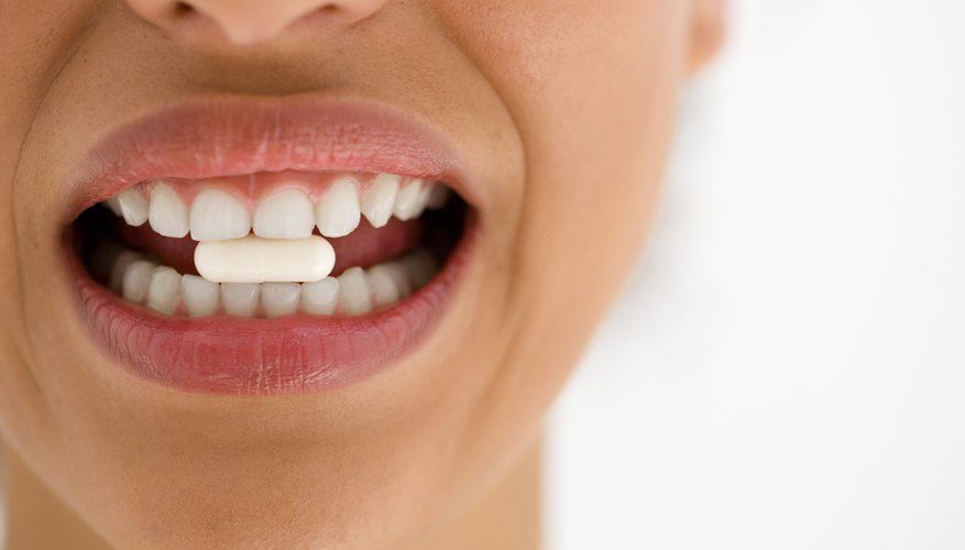 woman with oral drug in her mouth woman with oral drug in her mouth