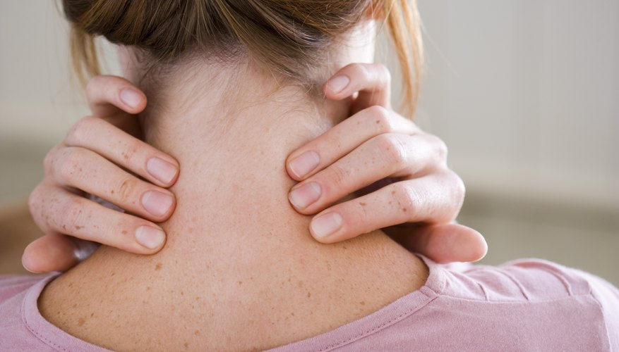 Woman touching neck Woman touching neck
