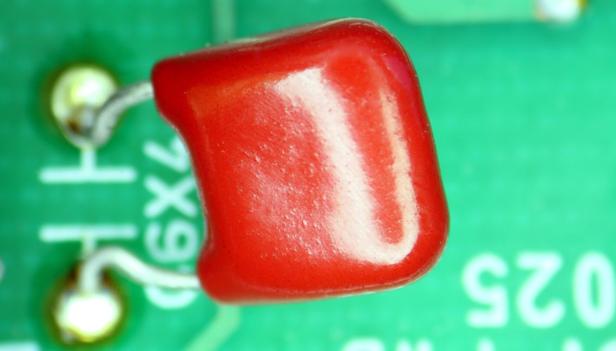 Photo Credit: Jupiterimages/Photos.com/Getty Images Ceramic capacitors hold electric charges on plates separated by insulators.