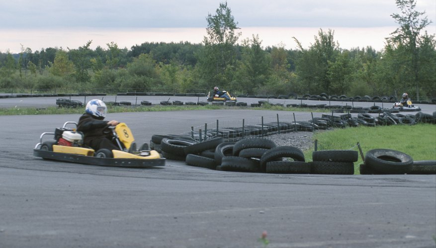 Go-cart racers driving on tire lined track