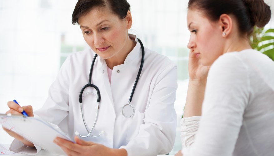 Photo Credit: Alexander Raths/iStock/Getty Images Doctor talking with teen patient