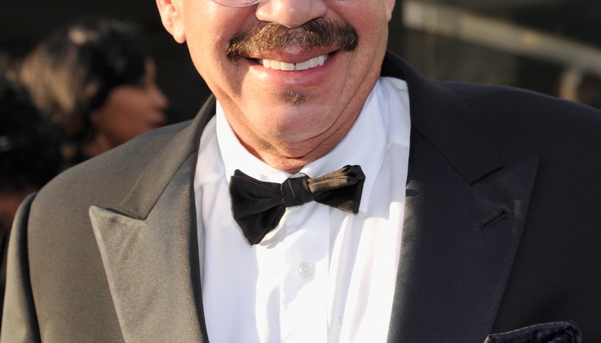 Smiling Tom Joyner in suit at event