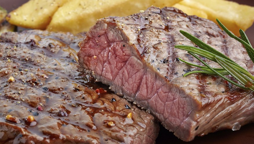 Photo Credit: Magone/iStock/Getty Images Grilled steak on a wooden cutting board.