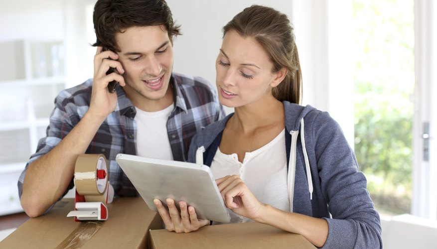 Young couple surrounded by moving boxes