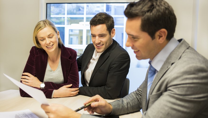 Couple meeting real-estate agent to buy property