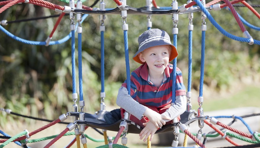 Child sitting on playground equipment Child sitting on playground equipment