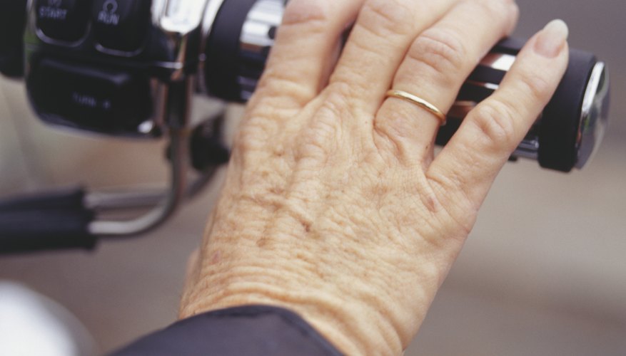 Woman riding motorcycle, close-up of hand on handlebar